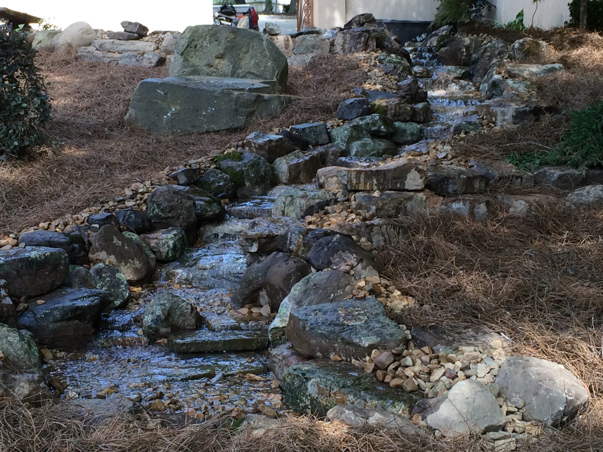 Pondless waterfall disappearing into gravel
