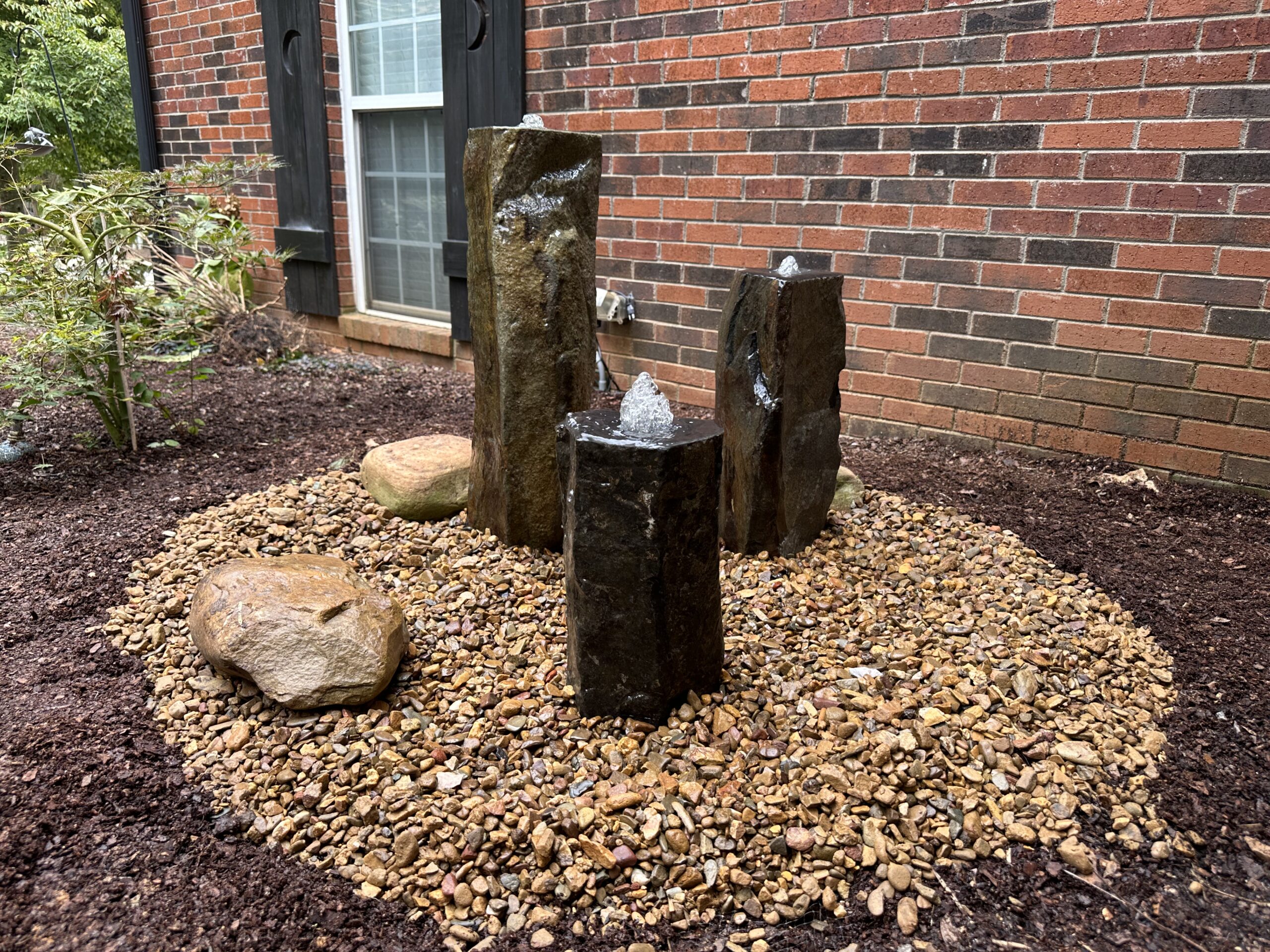 IMG_2846 Decorative bubbling boulder in a garden bed